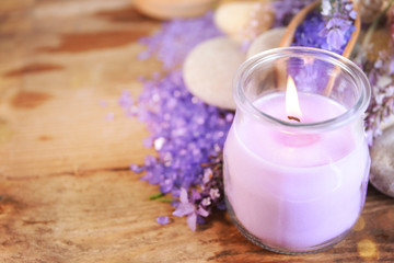 Obraz na płótnie Canvas lavender oil in a glass bottle on a background of fresh flowers. Aromatherapy.