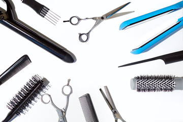 Professional combs and different hairdresser tools on white background top view. Copy space