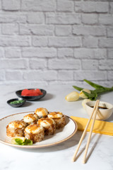 Close view on the plate of baked rolls with sauce