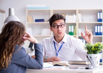 Sales assistant discussing transaction with customer