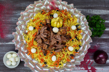 Samarkand pilaf on the Uzbek plate and chuk chuk salad on the wooden background