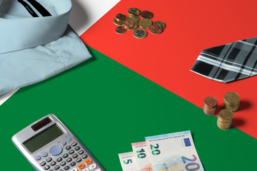 Madagascar flag on minimal money concept table. Coins and financial objects on flag surface. National economy theme.