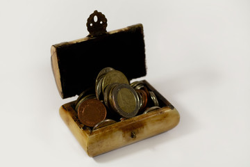 A treasure chest filled with coins isolated
