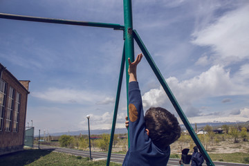 young boy attracted to horizontal bar