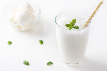 Vanilla Shake with Ice Cream and Mint on white background. Vanilla Ice Cream Milk Shake. Banana Smoothie with Mint and Vanilla.
