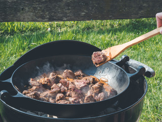 outdoor beef goulash - traditional beef stew in dutch oven