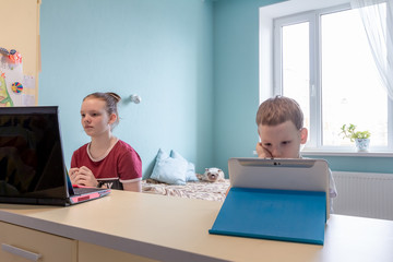 School Kids with Computers Distance Education Classes. Children Studying from Home. Homeschooling During Quarantine. Online Remote Learning. Use Laptop and Tablet