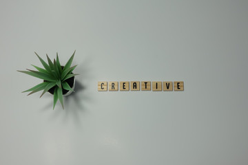 The word Creative spelled in wooden letter tiles in stop motion animation.