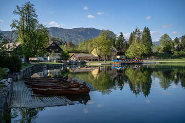 Bled, Sloveina, April 22, 2020: Lake shore with all the boats tied to the dock, due to coronavirus lockdown. Tourism in for trouble.