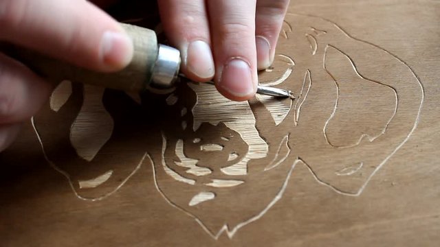 The process of creating a picture of wood. Art wood carving. Hobby
