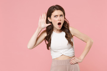 Shocked young brunette woman girl in light casual clothes posing isolated on pastel pink background...
