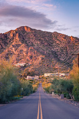 Camelback mountain rises at the far end of a street in Phoenix, Arizona. The mountain is the home...