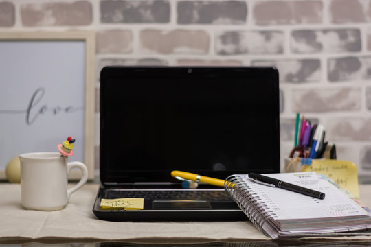home office work with laptop planner and desk pens