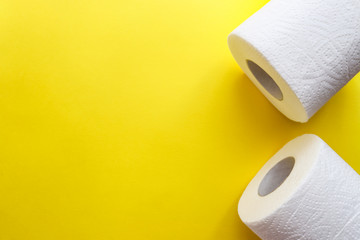 Toilet paper on yellow background. The hygiene and sanitary product concept. Concept of crisis, coronavirus, quarantine. Closeup. Top view
