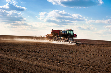 self-propelled sprayer in the field makes fertilizers in early spring