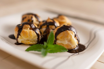 Profiteroles with cream and chocolate.