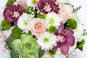 A bouquet of flowers from ornamental cabbage, orchids, roses, chrysanthemums. Floral background