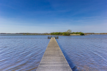 Obraz premium Wooden jetty at the Oldambtmeer lake in Oostwold, Netherlands