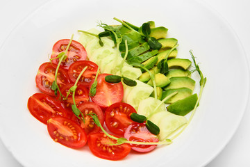 top view mix fresh vegetable diet salad with tomatoes cucumbers avocado  on white dish