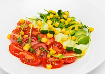 top view mix fresh vegetable diet salad with tomatoes cucumbers avocado  on white dish