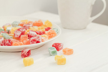 Delicious multi-colored lokum in a white plate. Turkish delight.