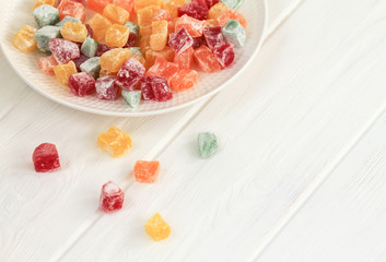 Delicious multi-colored lokum in a white plate. Turkish delight.