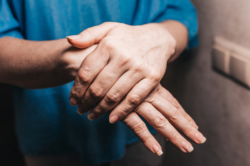 Smooth shiny skin of female hands after applying a protective cream - a remedy for wrinkles and dry skin