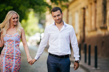 Fototapeta premium Young couple in love hug each other on city background