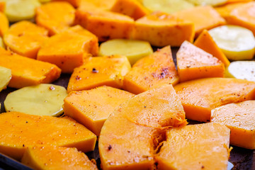 Pumpkin and potatoes on a baking tray