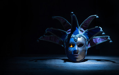 Carnival venetian mask with fire in the eye in night