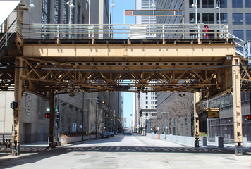 Nearly deserted Clark Street at a CTA elevated train station in downtown Chicago during the COVID19 shelter-in-place order
