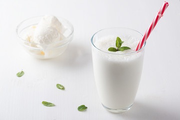 Vanilla Shake with Ice Cream and Mint on white background. Vanilla Ice Cream Milk Shake. Banana Smoothie with Mint and Vanilla
