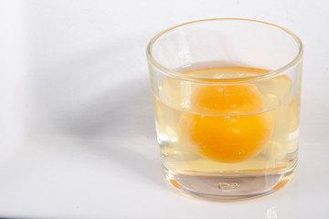 raw egg in glass close up