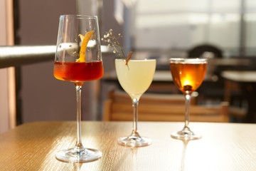 Three simple looking cocktails in bar