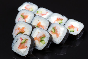 Sushi rolls Futo Maki on a black background.