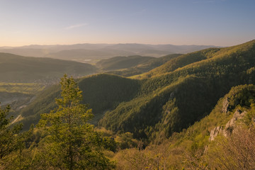 Fototapeta premium View of the countryside under the mountains at sunset.