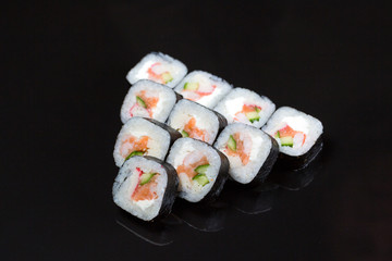 Sushi rolls Futo Maki on a black background.