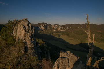 View of the countryside under the mountains at sunset.
