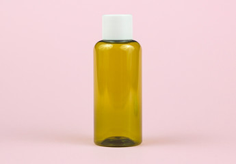 Brown medical bottle on a pink background.