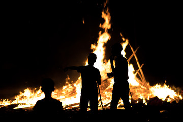 Silhouette of children on the background of the Lag Baomer bonfire, (to the editor: the Jewish...