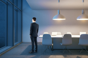 Businessman standing in conference room
