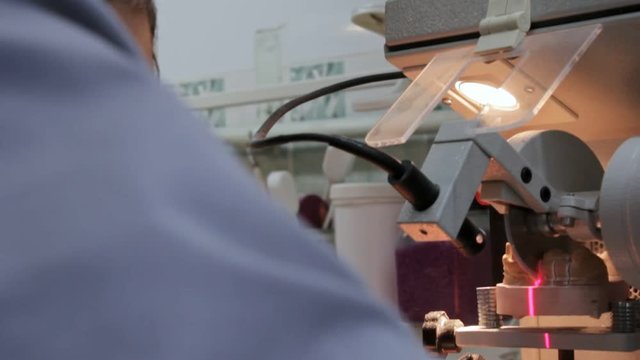 Prosthetist a small circular saw cuts through the dental prosthesis, Full HD