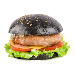 Black burger with beef cutlet, cheese, tomato, onion, lettuce and sauce isolated on white background.