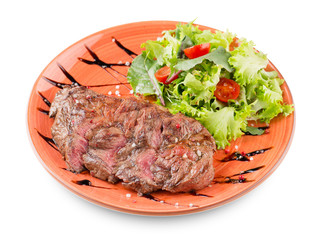 Grilled sliced Beef Steak with salad, tomatoes and sauce on a orange plate Isolated on white