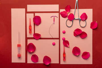 set of medical items: intrauterine device, tablets, contraceptives used in gynecology.