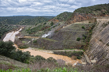 Fototapeta na wymiar Reservoir Jándula, expelling water after several months of rain, Jaen, Spain