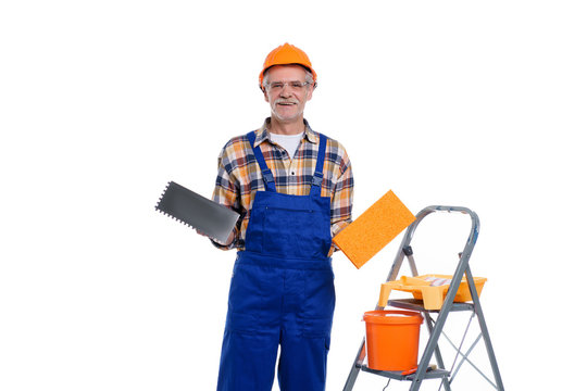 Senior male with mustache, builder isolated on white background, man worker with building helmet, plastering tools. Mason tools, builder concept