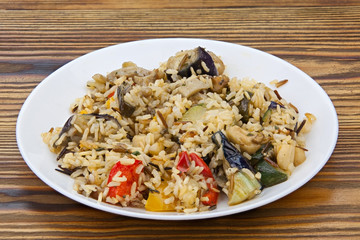 stewed vegetables with rice on a plate on  wooden background