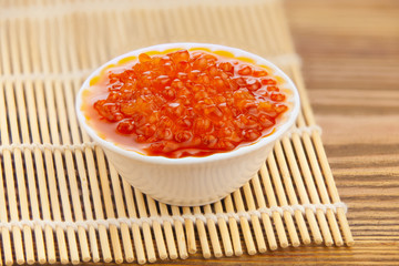 delicious appetizing sandwich with red caviar on  wooden