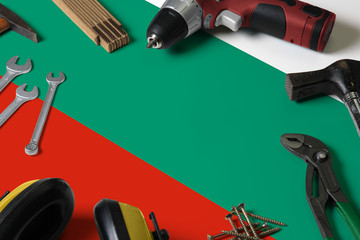 Bulgaria flag on repair tool concept wooden table background. Mechanical service theme with national objects.